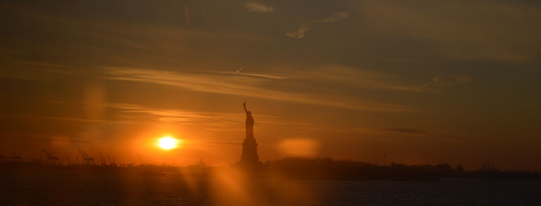 A photo of the Statue of Liberty in New York during a sunset