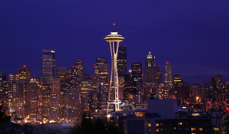 A photo of the Seattle skyline at night, with the Space Needle lighted